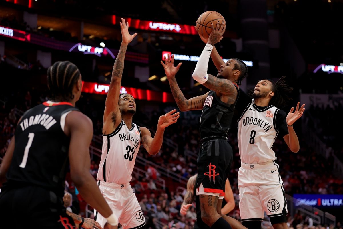 Feb 1, 2025; Houston, Texas, USA; Houston Rockets guard Jalen Green (4) shoots inside against Brooklyn Nets center Nic Claxton (33) and Brooklyn Nets forward Ziaire Williams (8) during the first quarter at Toyota Center. Mandatory Credit: Erik Williams-Imagn Images