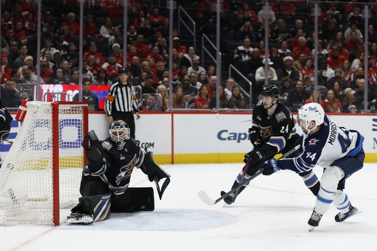 Feb 1, 2025; Washington, District of Columbia, USA; Winnipeg Jets defenseman Josh Morrissey (44) scores the game winning goal in overtime on Washington Capitals goaltender Logan Thompson (48) as Capitals center Connor McMichael (24) defends at Capital One Arena. Mandatory Credit: Geoff Burke-Imagn Images