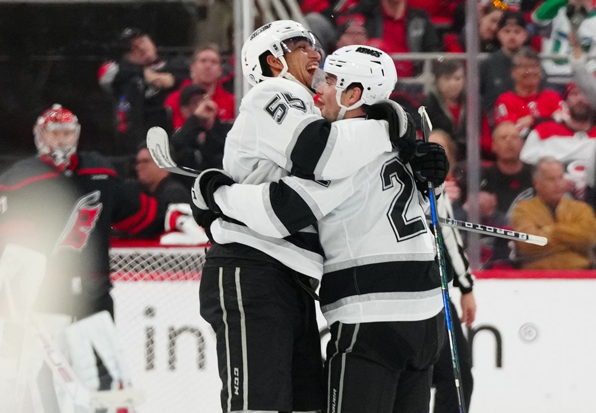 Feb 1, 2025; Raleigh, North Carolina, USA;  Los Angeles Kings left wing Kevin Fiala (22) celebrates his goal with right wing Quinton Byfield (55) against the Carolina Hurricanes during the third period at Lenovo Center. Mandatory Credit: James Guillory-Imagn Images