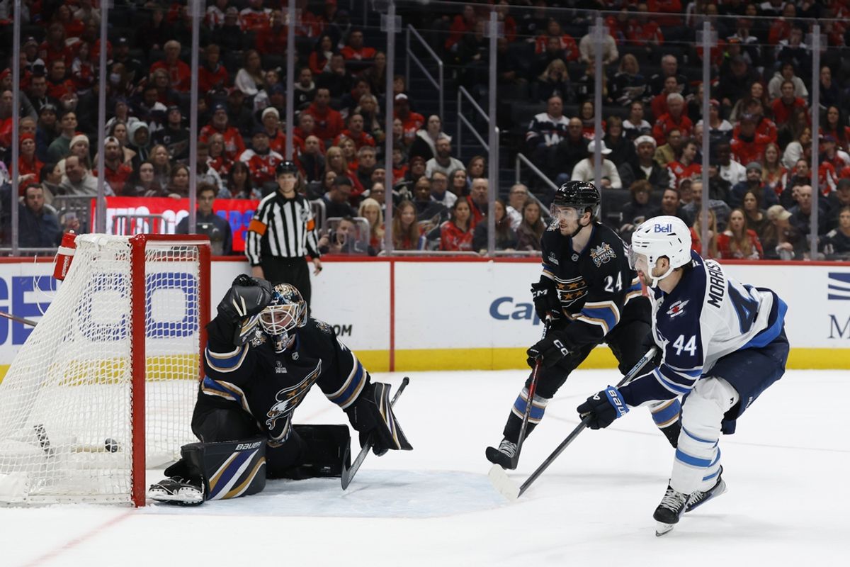Feb 1, 2025; Washington, District of Columbia, USA; Winnipeg Jets defenseman Josh Morrissey (44) scores the game winning goal in overtime on Washington Capitals goaltender Logan Thompson (48) as Capitals center Connor McMichael (24) defends at Capital One Arena. Mandatory Credit: Geoff Burke-Imagn Images