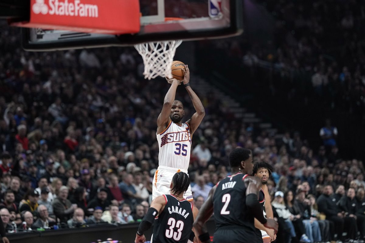 Feb 1, 2025; Portland, Oregon, USA;  Phoenix Suns power forward Kevin Durant (35) shoots the ball over Portland Trail Blazers forward Toumani Camara (33) during the first half at Moda Center. Mandatory Credit: Soobum Im-Imagn Images