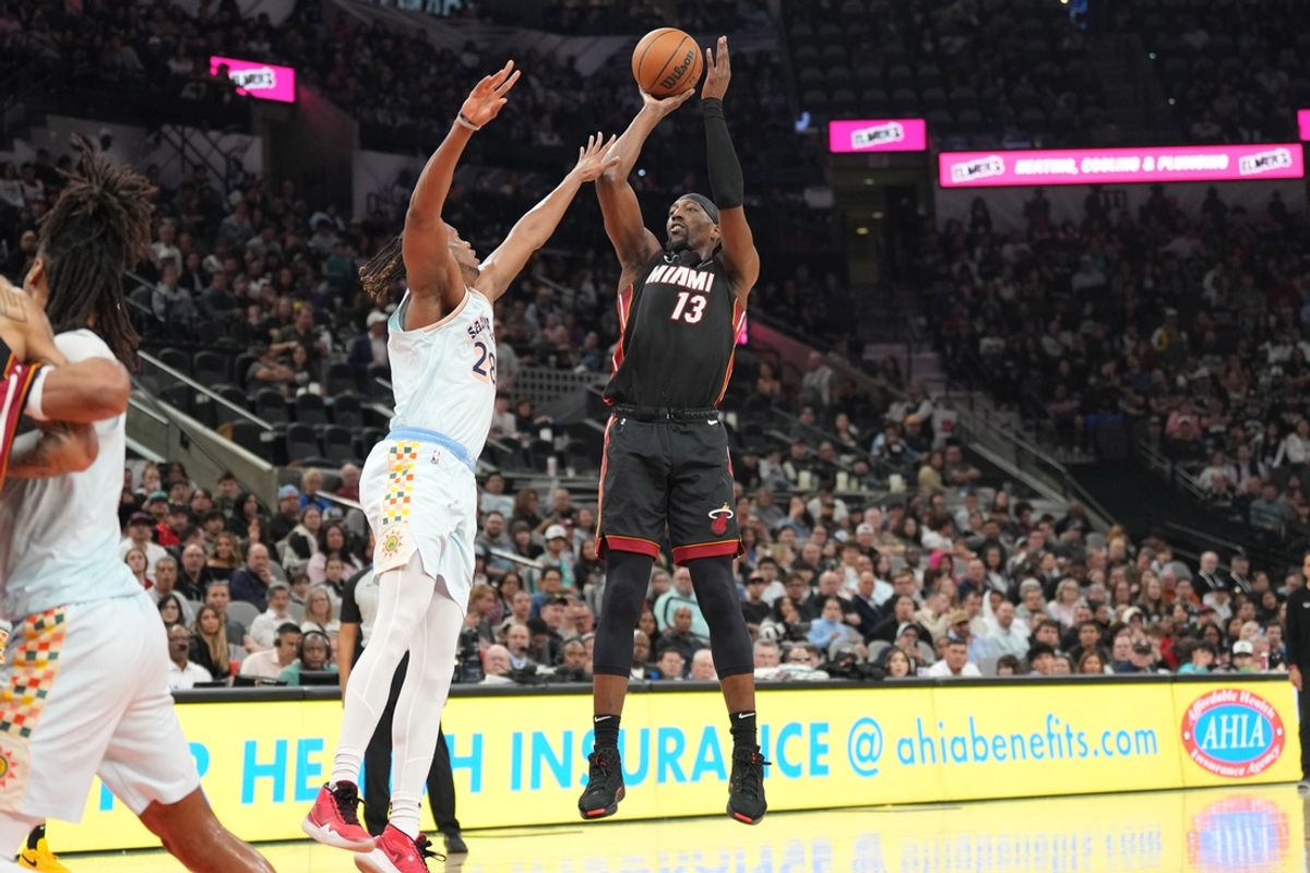 Feb 1, 2025; San Antonio, Texas, USA; Miami Heat center Bam Adebayo (13) shoots over San Antonio Spurs center Charles Bassey (28) during the second half at Frost Bank Center. Mandatory Credit: Scott Wachter-Imagn Images