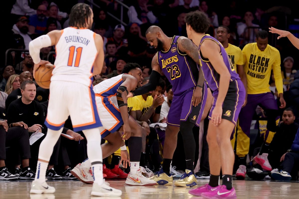 Feb 1, 2025; New York, New York, USA; New York Knicks forward OG Anunoby (8) reacts to an apparent injury as Los Angeles Lakers forward LeBron James (23) helps him up during the third quarter at Madison Square Garden. Mandatory Credit: Brad Penner-Imagn Images