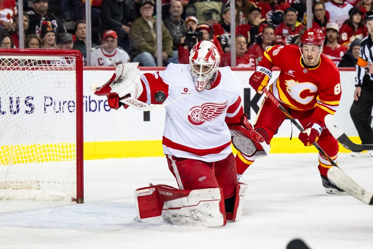 Feb 1, 2025; Calgary, Alberta, CAN; Detroit Red Wings goaltender Cameron Talbot (39) hits an airborne puck with his stick during the second period against the Calgary Flames at Scotiabank Saddledome. Mandatory Credit: Brett Holmes-Imagn Images