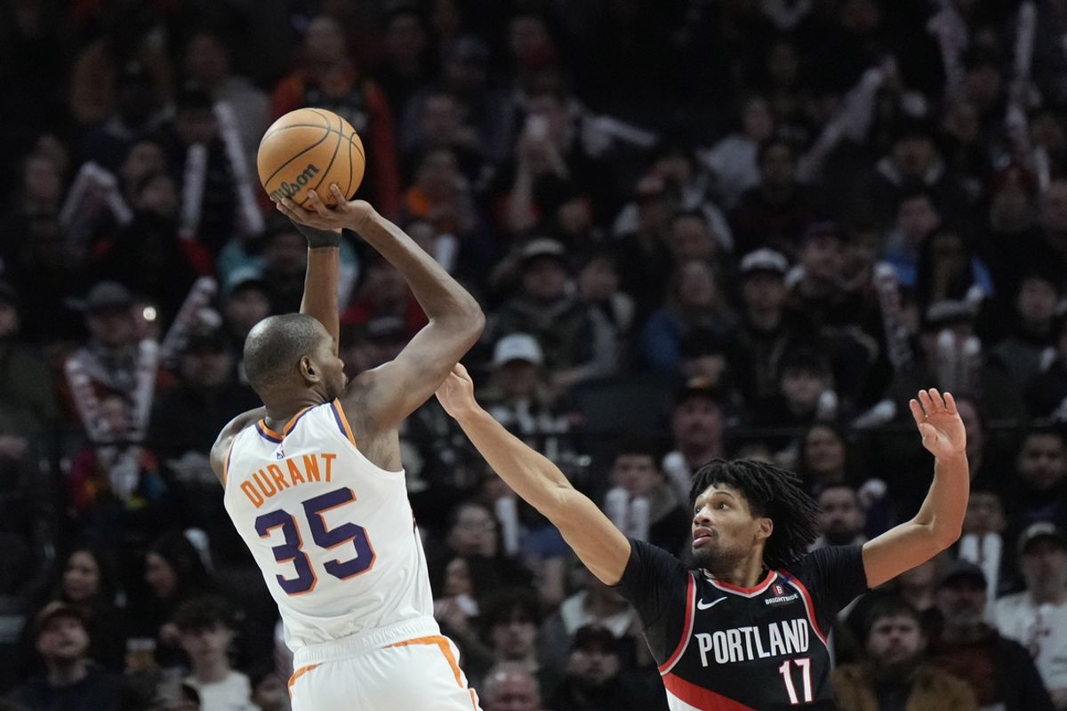 Feb 1, 2025; Portland, Oregon, USA; Phoenix Suns power forward Kevin Durant (35) shoots the ball over Portland Trail Blazers shooting guard Shaedon Sharpe (17) during the second half at Moda Center. Mandatory Credit: Soobum Im-Imagn Images