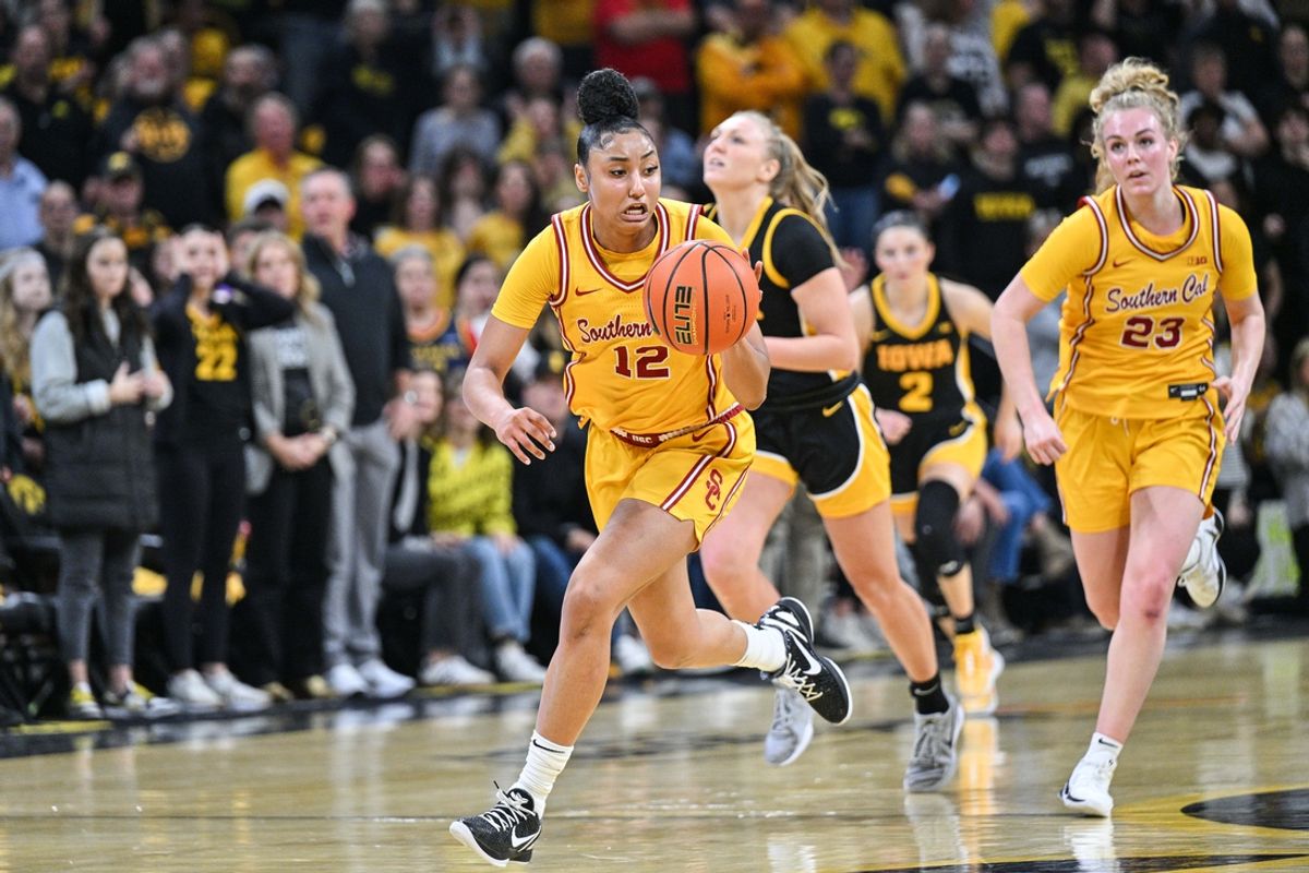 Feb 2, 2025; Iowa City, Iowa, USA; USC Trojans guard JuJu Watkins (12) drives the ball late during the second quarter against the Iowa Hawkeyes as guard Avery Howell (23) looks on at Carver-Hawkeye Arena. Mandatory Credit: Jeffrey Becker-Imagn Images