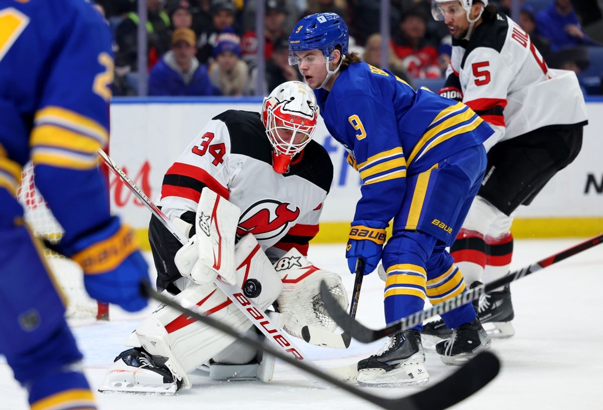 Feb 2, 2025; Buffalo, New York, USA;  Buffalo Sabres left wing Zach Benson (9) looks for a rebound as New Jersey Devils goaltender Jake Allen (34) makes a save during the second period at KeyBank Center. Mandatory Credit: Timothy T. Ludwig-Imagn Images