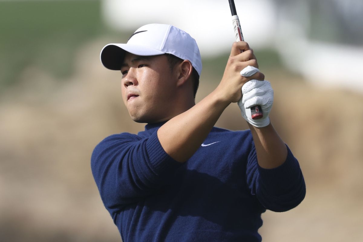 Feb 2, 2025; Pebble Beach, California, USA; Tom Kim hits his second shot on the fourth hole during the final round of the AT&T Pebble Beach Pro-Am golf tournament at Pebble Beach Golf Links. Mandatory Credit: Kiyoshi Mio-Imagn Images