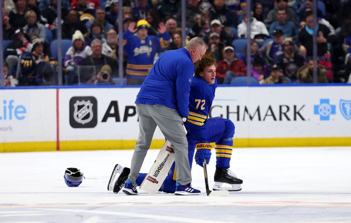 Feb 2, 2025; Buffalo, New York, USA;  A trainer attends to Buffalo Sabres center Tage Thompson (72) after getting hurt during the third period against the New Jersey Devils at KeyBank Center. Mandatory Credit: Timothy T. Ludwig-Imagn Images