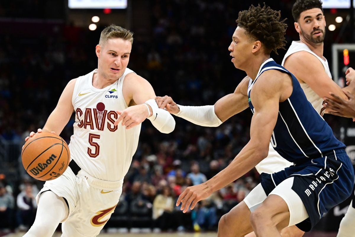 Feb 2, 2025; Cleveland, Ohio, USA; Cleveland Cavaliers guard Sam Merrill (5) drives to the basket against Dallas Mavericks forward Kessler Edwards (20) during the second half at Rocket Mortgage FieldHouse. Mandatory Credit: Ken Blaze-Imagn Images