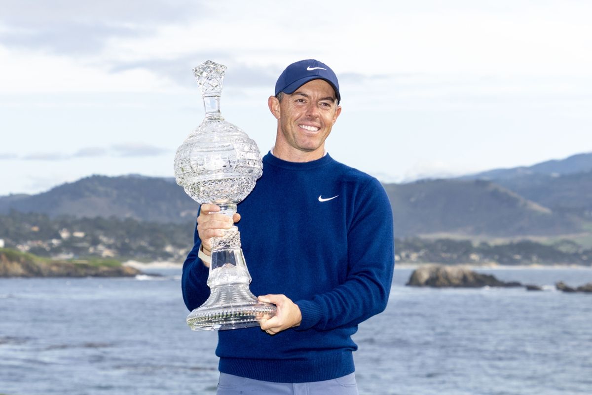February 2, 2025; Pebble Beach, California, USA; Rory McIlroy hoists the trophy during the final round of the AT&T Pebble Beach Pro-Am golf tournament at Pebble Beach Golf Links. Mandatory Credit: Kyle Terada-Imagn Images