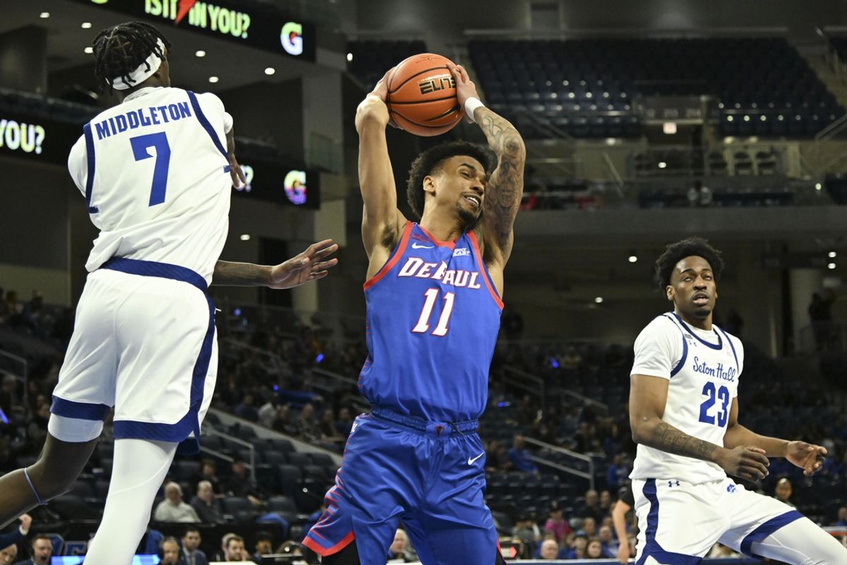 Feb 2, 2025; Chicago, Illinois, USA;  DePaul Blue Demons guard CJ Gunn (11) grabs a rebound during the first half against Seton Hall Pirates at Wintrust Arena. Mandatory Credit: Matt Marton-Imagn Images