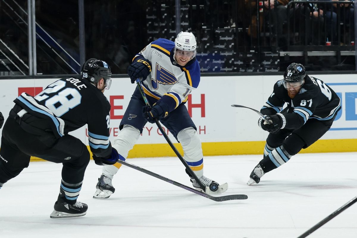 Feb 2, 2025; Salt Lake City, Utah, USA; St. Louis Blues center Radek Faksa (12) tries to shoot the puck past Utah Hockey Club defenseman Ian Cole (28) during the first period at Delta Center. Mandatory Credit: Chris Nicoll-Imagn Images