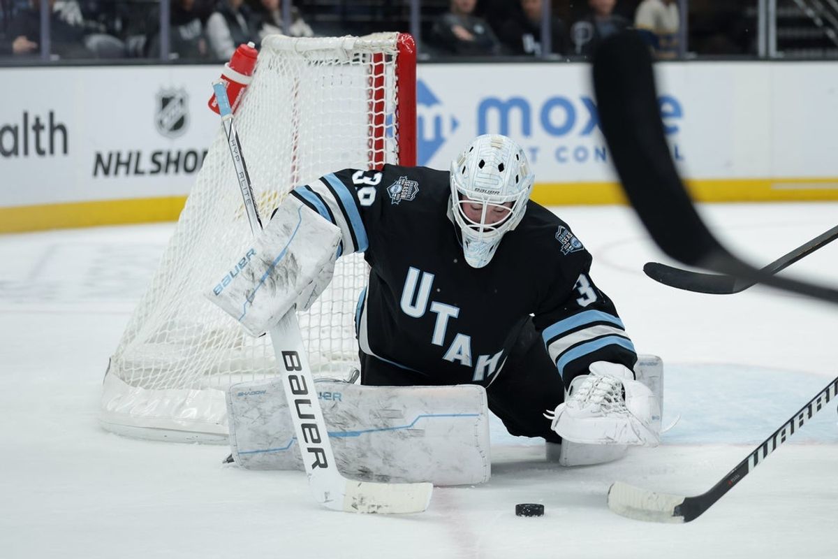 Feb 2, 2025; Salt Lake City, Utah, USA; Utah Hockey Club goaltender Connor Ingram (39) jumps on a loose puck during the first period against the St. Louis Blues at Delta Center. Mandatory Credit: Chris Nicoll-Imagn Images