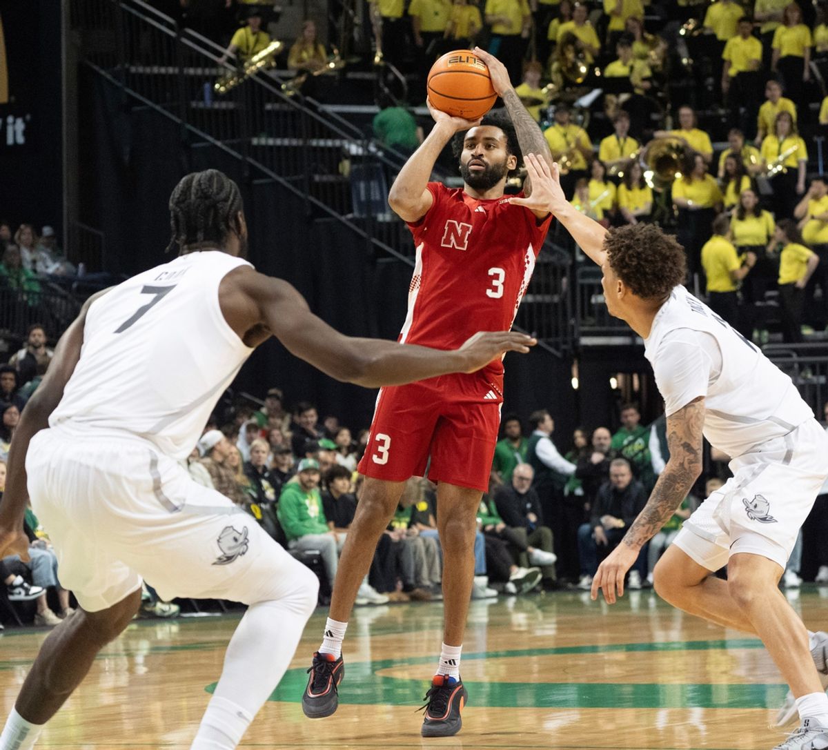 Nebraska’s Brice Williams, center, shoots over the Oregon defense during the first half at Matthew Knight Arena Feb. 2, 2025.