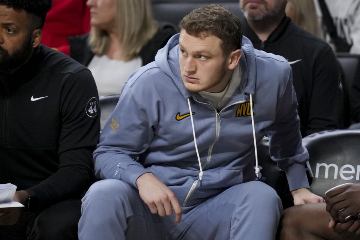 Feb 2, 2025; Cincinnati, Ohio, USA;  West Virginia Mountaineers’ Tucker DeVries watches from the bench in the game against the Cincinnati Bearcats in the second half at Fifth Third Arena. Mandatory Credit: Aaron Doster-Imagn Images