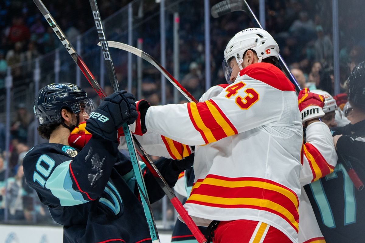 Feb 2, 2025; Seattle, Washington, USA;  Seattle Kraken forward Matty Beniers (10), left, and Calgary Flames forward Adam Klapka (43) scuffle during the second period at Climate Pledge Arena. Mandatory Credit: Stephen Brashear-Imagn Images