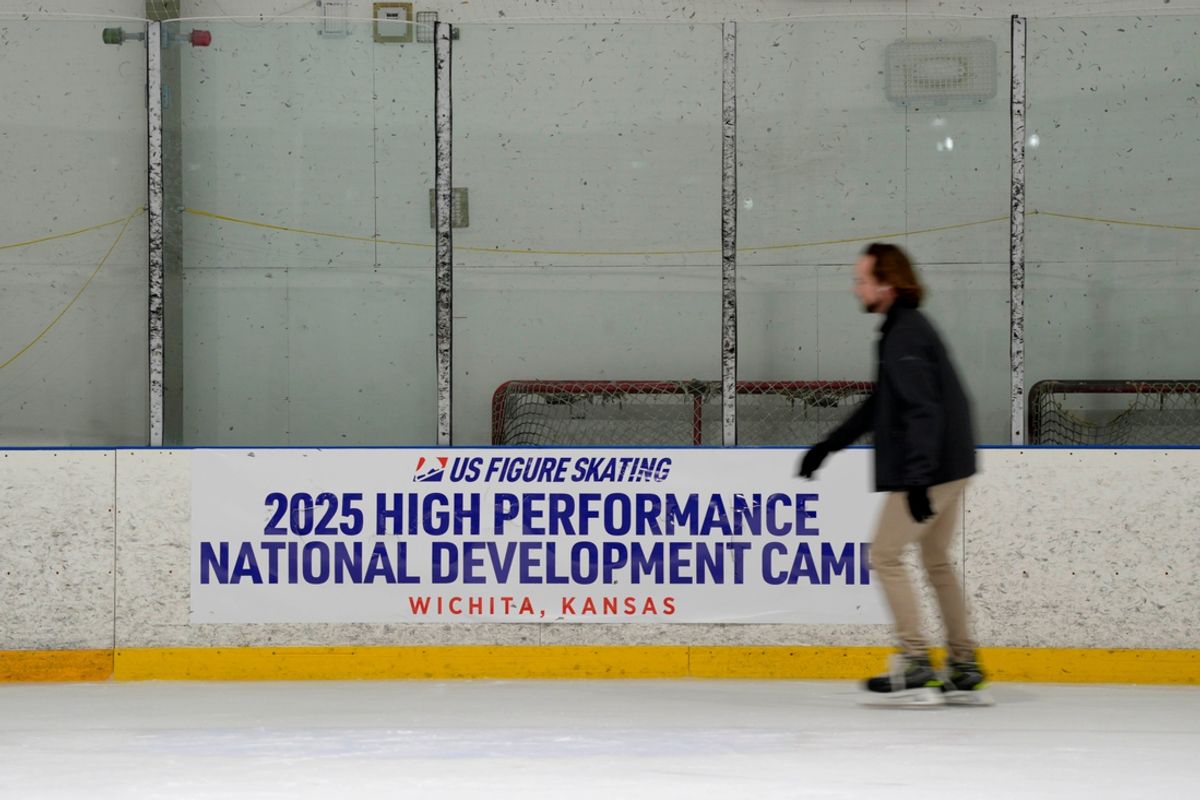 A skater moves past a US Figure Skating camp sign at the Wichita Ice Center on Thursday, Jan. 30, 2025. Airlines Flight 5342 took off from Wichita before colliding with an Army helicopter near the Reagan Washington National Airport in Washington, D.C.