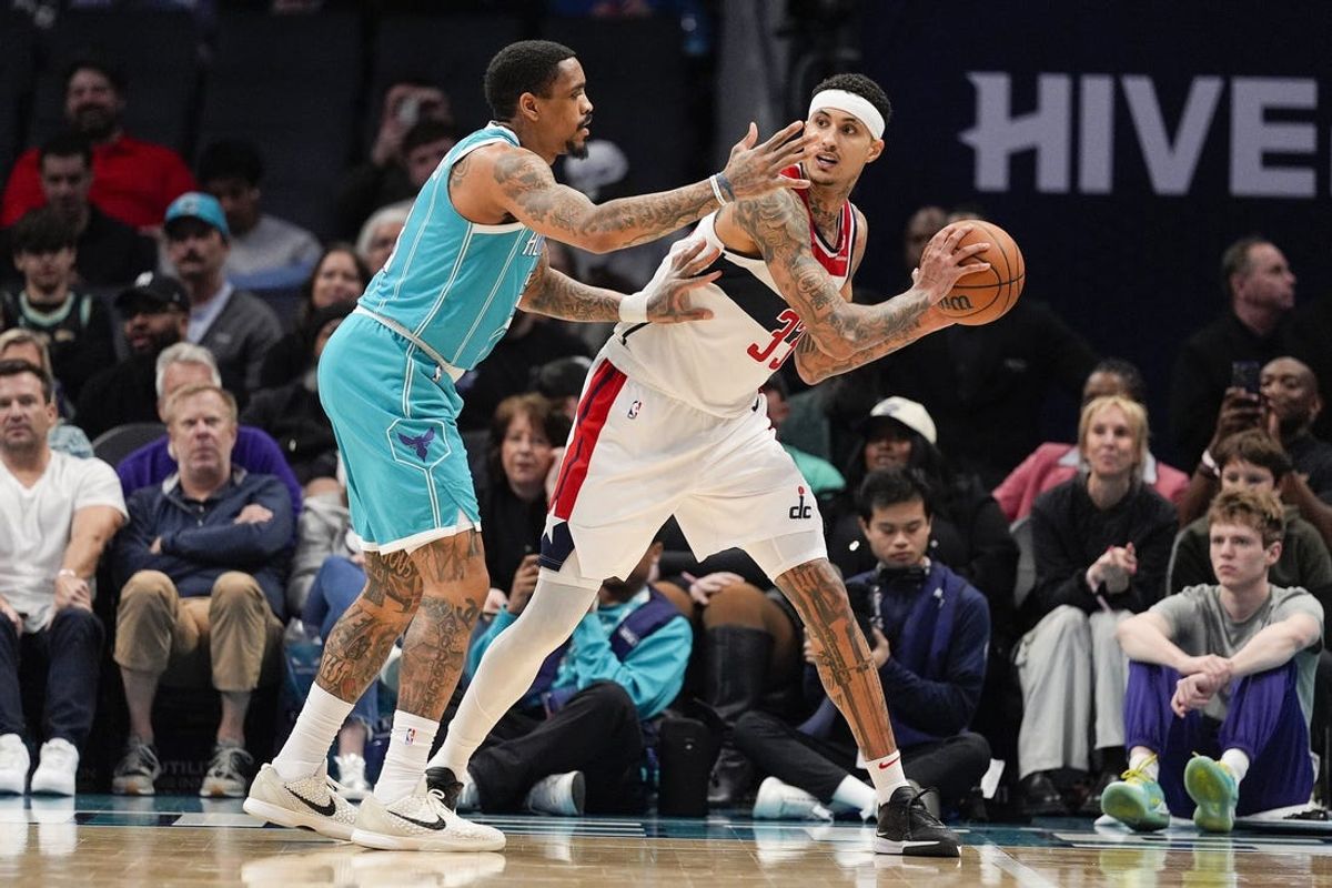 Feb 3, 2025; Charlotte, North Carolina, USA; Washington Wizards forward Kyle Kuzma (33) handles the ball against Charlotte Hornets guard DaQuan Jeffries (3) during the first half at Spectrum Center. Mandatory Credit: Jim Dedmon-Imagn Images