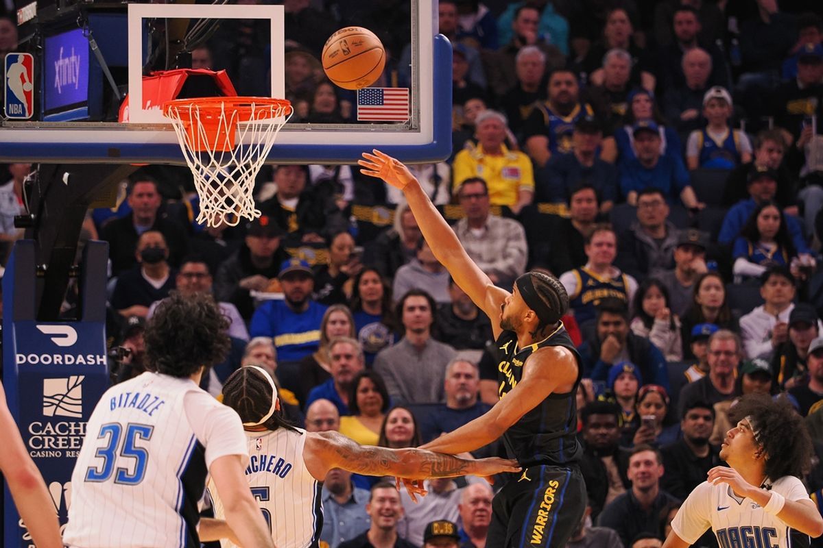 Feb 3, 2025; San Francisco, California, USA; Golden State Warriors guard Moses Moody (4) scores a basket against Orlando Magic forward Paolo Banchero (5) during the second quarter at Chase Center. Mandatory Credit: Kelley L Cox-Imagn Images