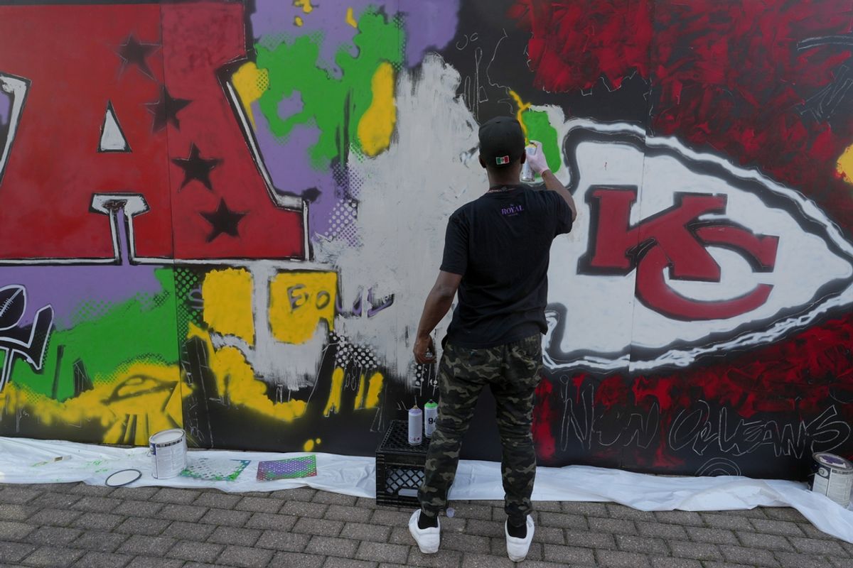 Feb 3, 2025; New Orleans, LA, USA; An artist paints a Kansas City Chiefs mural at the Caesars Superdome. Mandatory Credit: Kirby Lee-Imagn Images
