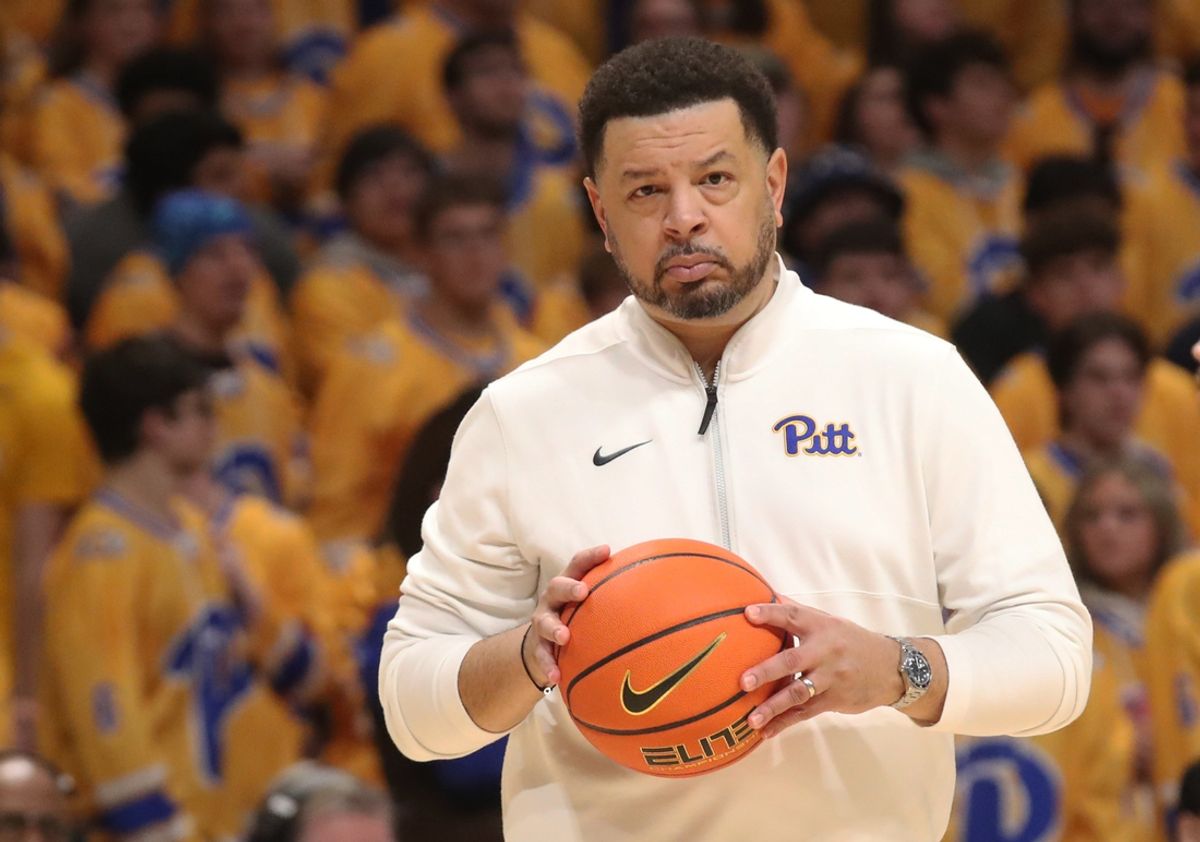 Feb 3, 2025; Pittsburgh, Pennsylvania, USA;  Pittsburgh Panthers head coach Jeff Capel grabs a lose ball during a time-out against the Virginia Cavaliers in the first half at the Petersen Events Center. Mandatory Credit: Charles LeClaire-Imagn Images