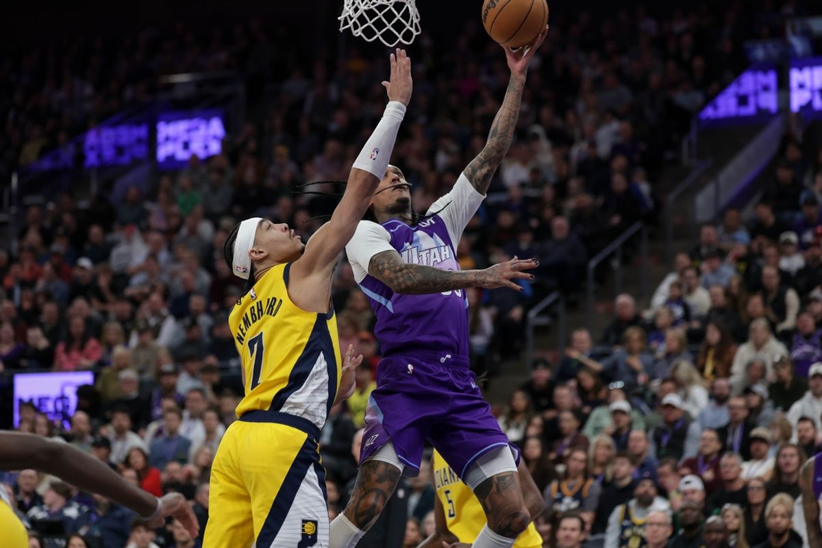 Feb 3, 2025; Salt Lake City, Utah, USA;  Utah Jazz guard Jordan Clarkson (00) jumps past Indiana Pacers guard Andrew Nembhard (2) and shoots the ball during the second quarter at Delta Center. Mandatory Credit: Chris Nicoll-Imagn Images