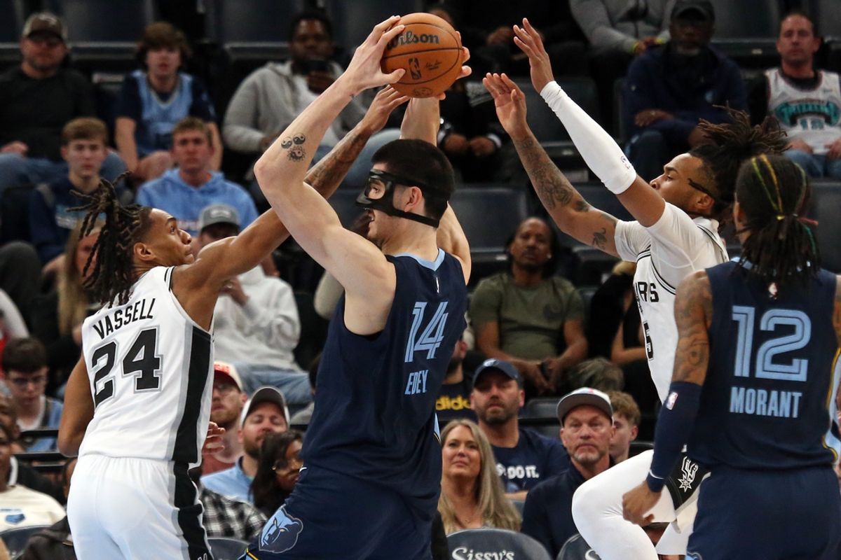 Feb 3, 2025; Memphis, Tennessee, USA; Memphis Grizzlies center Zach Edey (14) handles the ball as San Antonio Spurs guard Devin Vassell (24) defends during the fourth quarter at FedExForum. Mandatory Credit: Petre Thomas-Imagn Images
