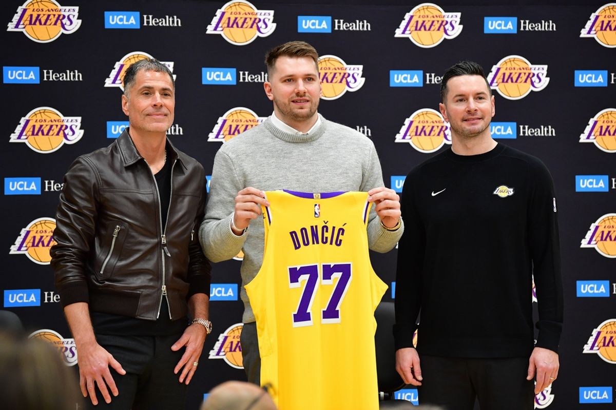 Feb 4, 2025; El Segundo, CA, USA; Los Angeles Lakers guard Luka Doncic poses for photos with general manager Rob Pelinka and head coach JJ Redick at UCLA Health Training Center. Mandatory Credit: Gary A. Vasquez-Imagn Images
