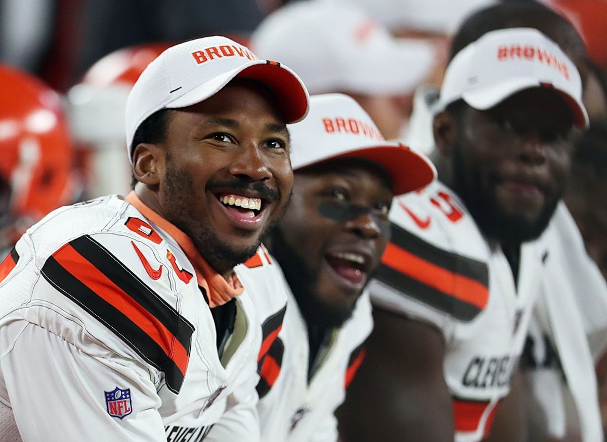 Cleveland Browns defensive end Myles Garrett (left) laughs as he watches a video on the scoreboard during the second quarter of a preseason football game against the Washington Redskins at FirstEnergy Stadium, Thursday, Aug. 8, 2019 in Cleveland, Ohio. [Jeff Lange/Beacon Journal/Ohio.com]