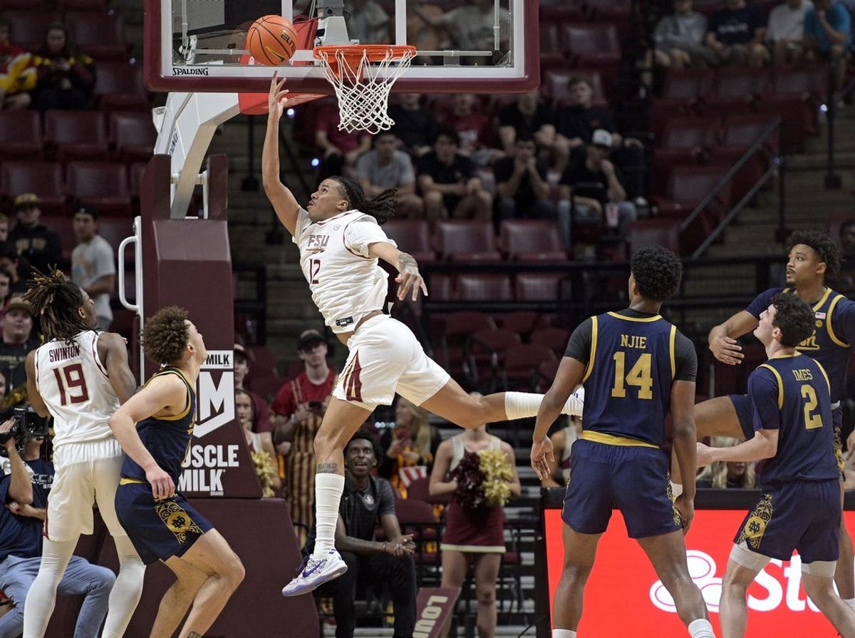 Feb 4, 2025; Tallahassee, Florida, USA; Florida State Seminoles forward Malique Ewin (12) makes a reverse layup during the first half against the Notre Dame Fighting Irish at Donald L. Tucker Center. Mandatory Credit: Melina Myers-Imagn Images