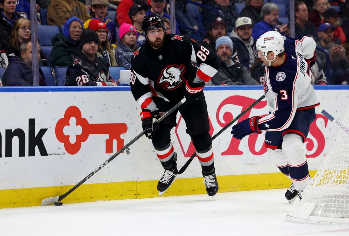 Feb 4, 2025; Buffalo, New York, USA;  Buffalo Sabres right wing Alex Tuch (89) looks to make a pass as Columbus Blue Jackets defenseman Jack Johnson (3) defends during the second period at KeyBank Center. Mandatory Credit: Timothy T. Ludwig-Imagn Images