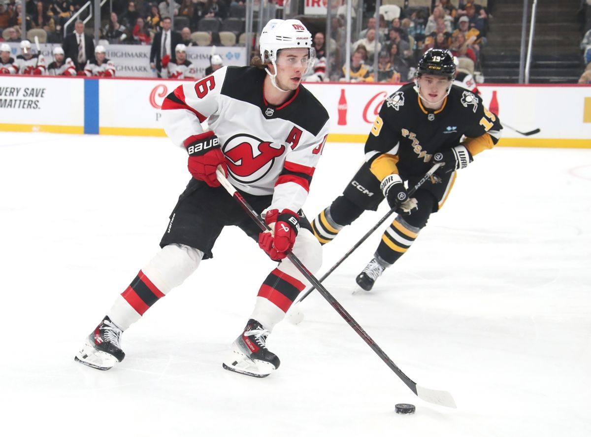 Feb 4, 2025; Pittsburgh, Pennsylvania, USA;  New Jersey Devils center Jack Hughes (86) skates with the puck against Pittsburgh Penguins center Cody Glass (19) during the second period at PPG Paints Arena. Mandatory Credit: Charles LeClaire-Imagn Images