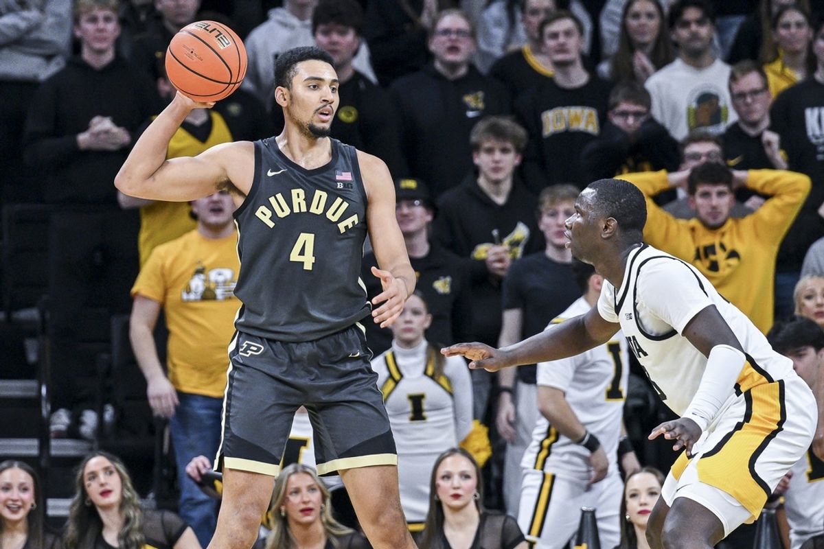 Feb 4, 2025; Iowa City, Iowa, USA; Purdue Boilermakers forward Trey Kaufman-Renn (4) controls the ball as Iowa Hawkeyes forward Ladji Dembele (13) defends during the second half at Carver-Hawkeye Arena. Mandatory Credit: Jeffrey Becker-Imagn Images