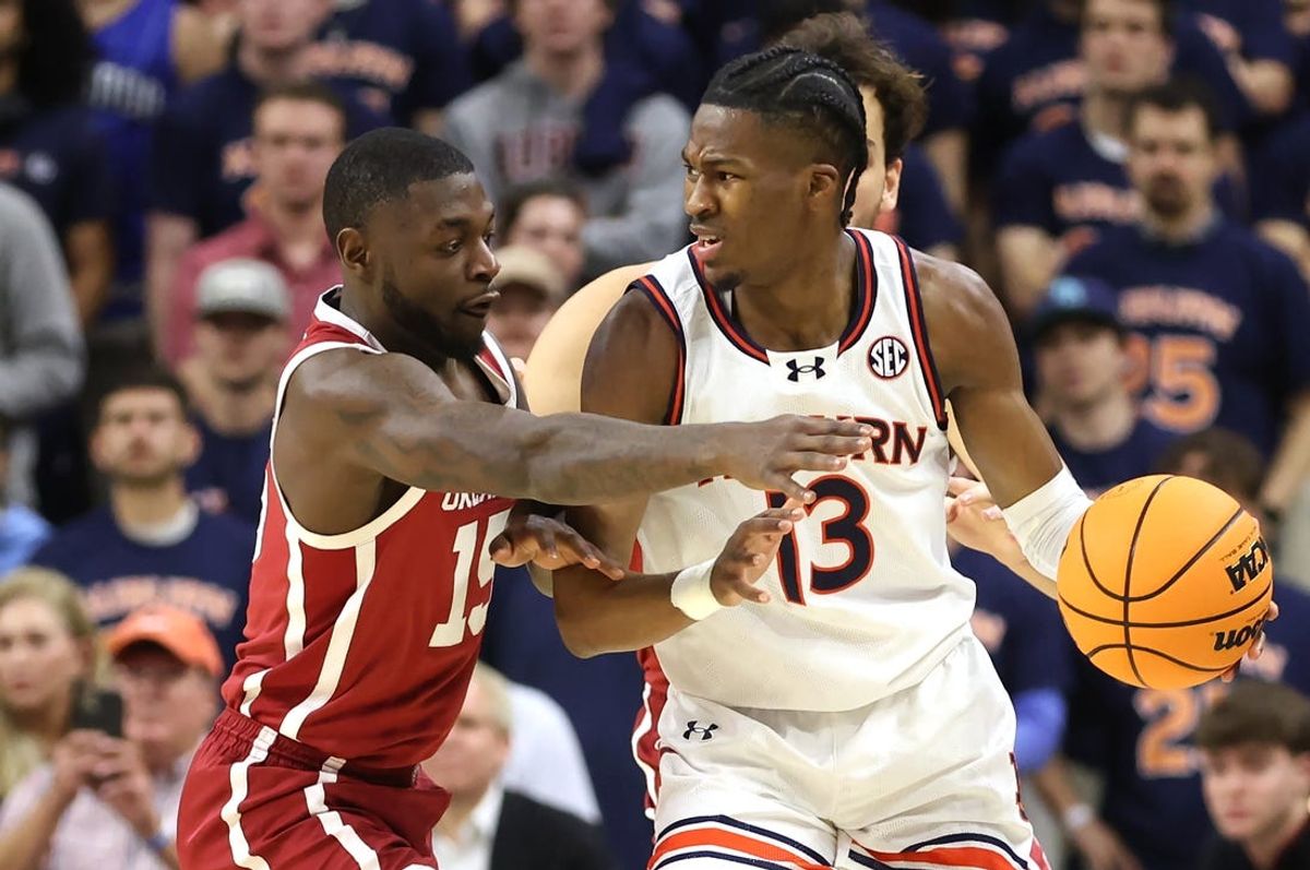 Feb 4, 2025; Auburn, Alabama, USA;  Oklahoma Sooners guard Duke Miles (15) tries to knock the ball away from Auburn Tigers guard Miles Kelly (13) during the first half at Neville Arena. Mandatory Credit: John Reed-Imagn Images