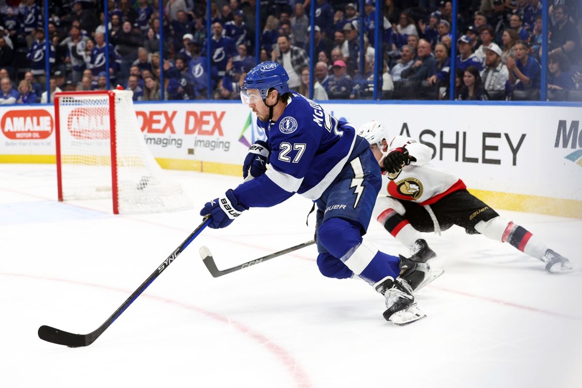 Feb 4, 2025; Tampa, Florida, USA;Tampa Bay Lightning defenseman Ryan McDonagh (27) scores an empty goal as Ottawa Senators center Tim Stützle (18) defends  during the third period at Amalie Arena. Mandatory Credit: Kim Klement Neitzel-Imagn Images