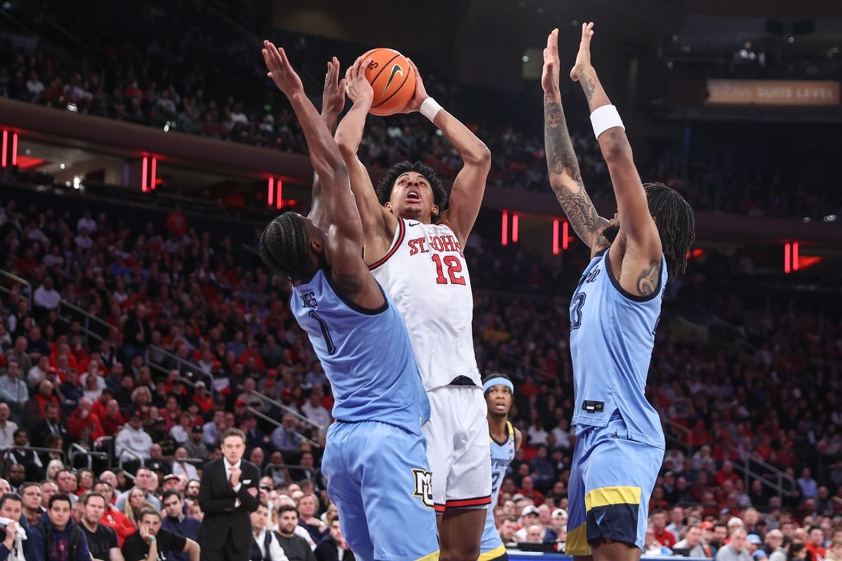 Feb 4, 2025; New York, New York, USA; St. John's Red Storm guard RJ Luis Jr. (12) looks to post up against Marquette Golden Eagles guard Kam Jones (1) in the second half at Madison Square Garden. Mandatory Credit: Wendell Cruz-Imagn Images