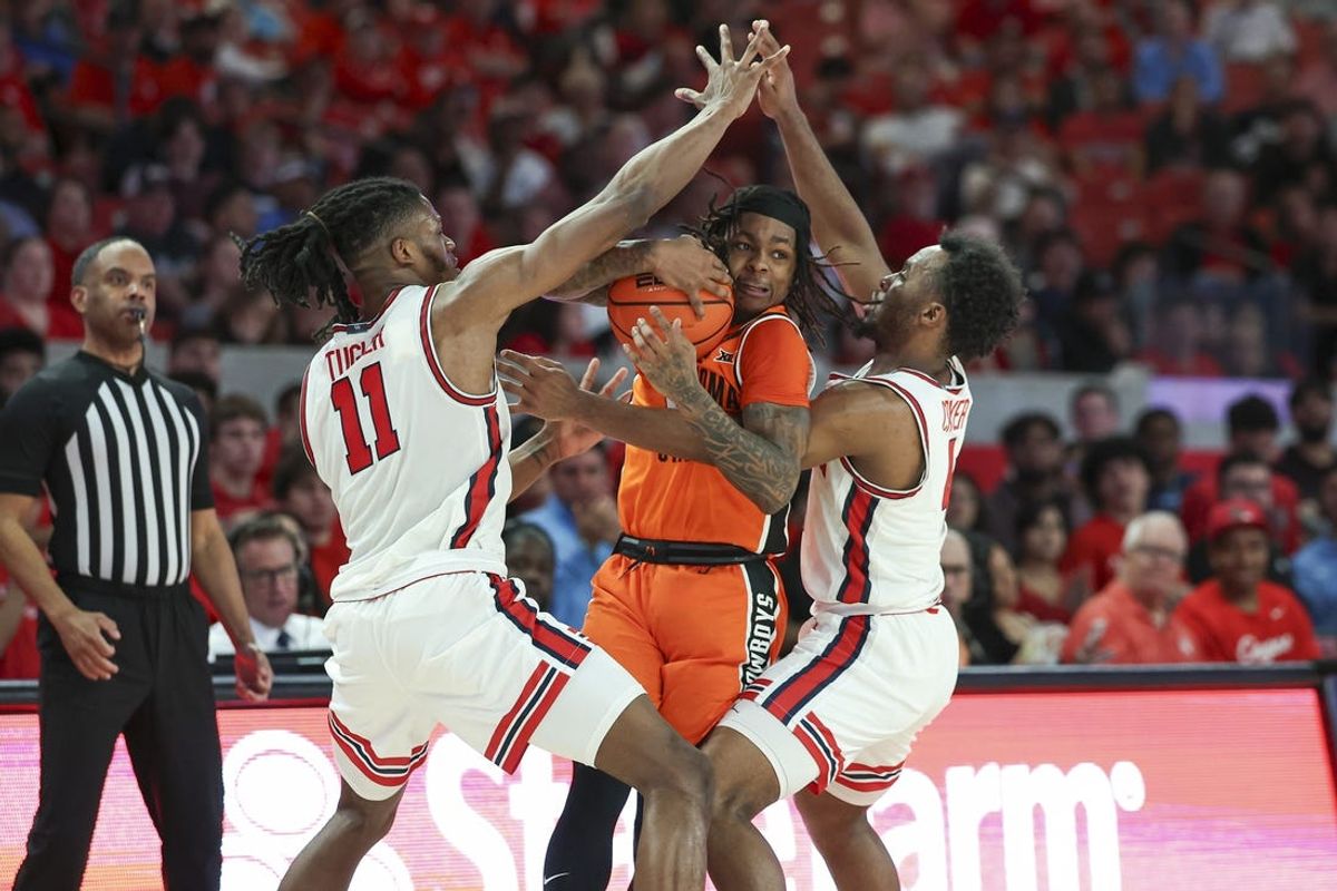 Feb 4, 2025; Houston, Texas, USA; Oklahoma State Cowboys guard Khalil Brantley (5) is defended by Houston Cougars forward Joseph Tugler (11) and guard L.J. Cryer (4) during the second half at Fertitta Center. Mandatory Credit: Troy Taormina-Imagn Images
