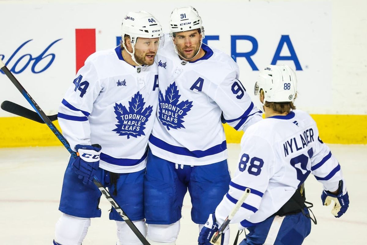 Feb 4, 2025; Calgary, Alberta, CAN; Toronto Maple Leafs center John Tavares (91) celebrates his goal (goal was later disallowed) with teammates against the Calgary Flames during the first period at Scotiabank Saddledome. Mandatory Credit: Sergei Belski-Imagn Images