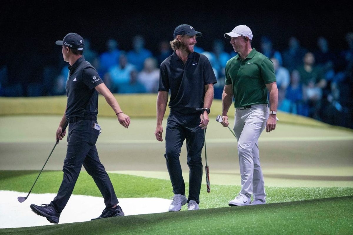 Tommy Fleetwood, center, of the Los Angeles Golf Club smiles at Rory McIlroy of Boston Common during a TGL match at the SoFi Center on February 4, 2025, in Palm Beach Gardens, Florida.