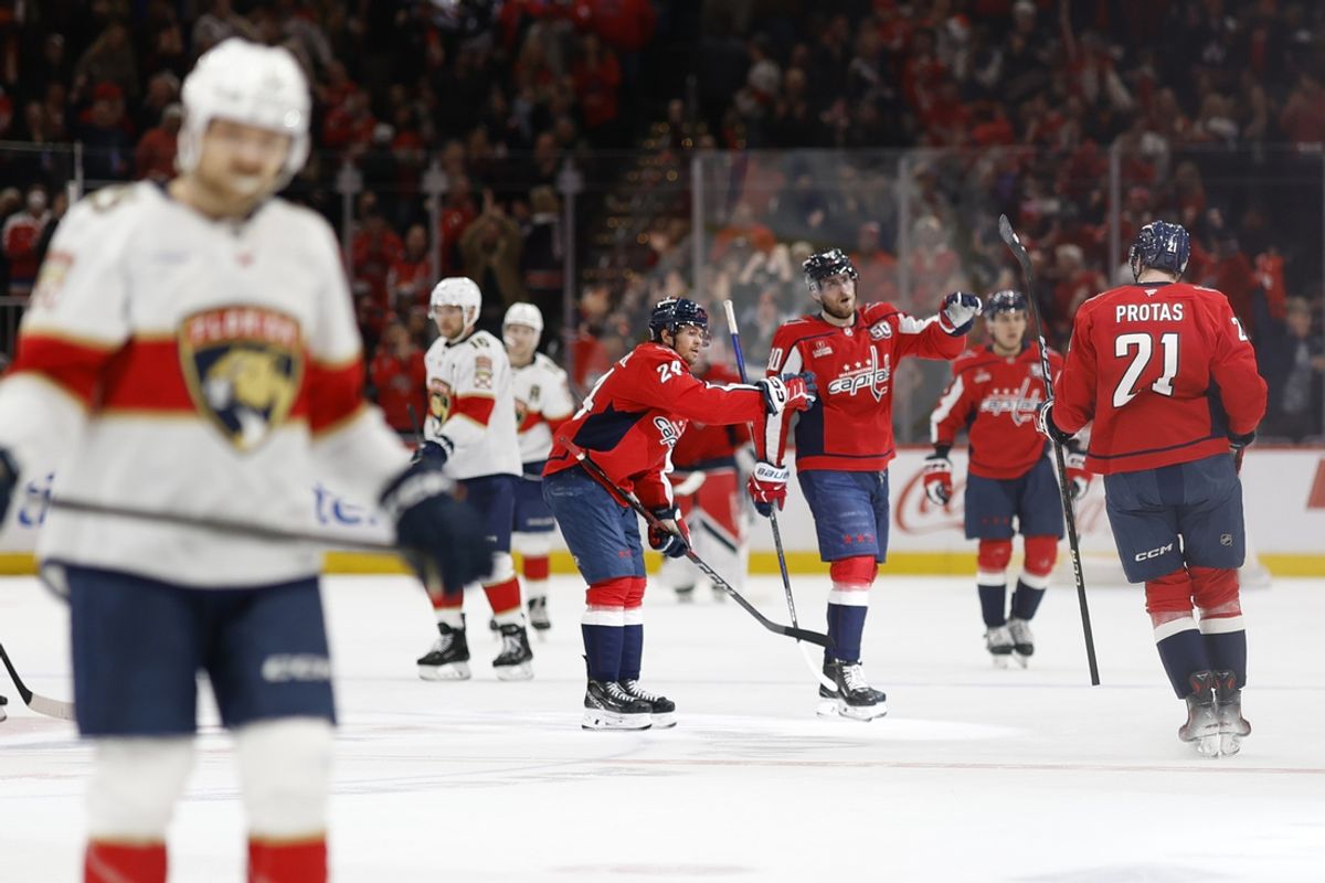 Feb 4, 2025; Washington, District of Columbia, USA; Washington Capitals center Aliaksei Protas (21) celebrates with teammates after scoring an empty net goal against the Florida Panthers in the third period at Capital One Arena. Mandatory Credit: Geoff Burke-Imagn Images