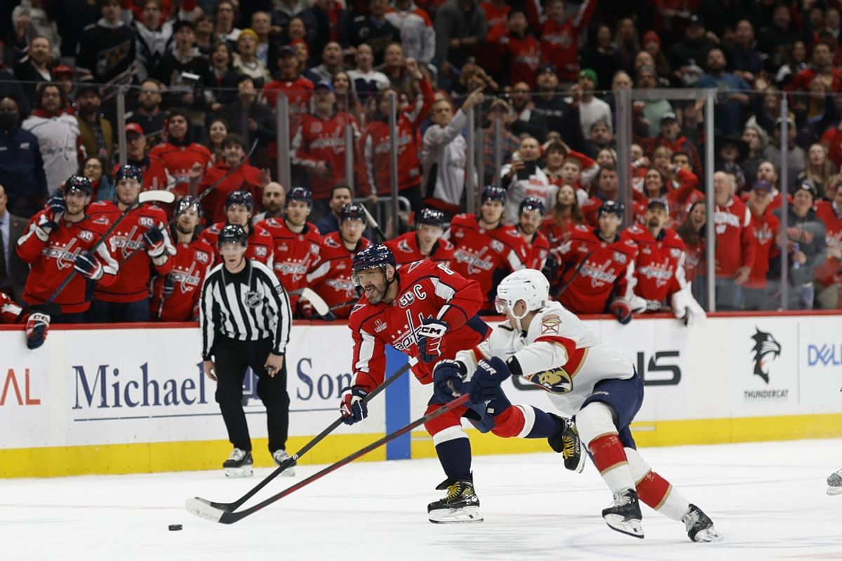 Feb 4, 2025; Washington, District of Columbia, USA; Washington Capitals left wing Alex Ovechkin (8) scores an empty net goal as Florida Panthers center Evan Rodrigues (17) defended in the third period at Capital One Arena. Mandatory Credit: Geoff Burke-Imagn Images