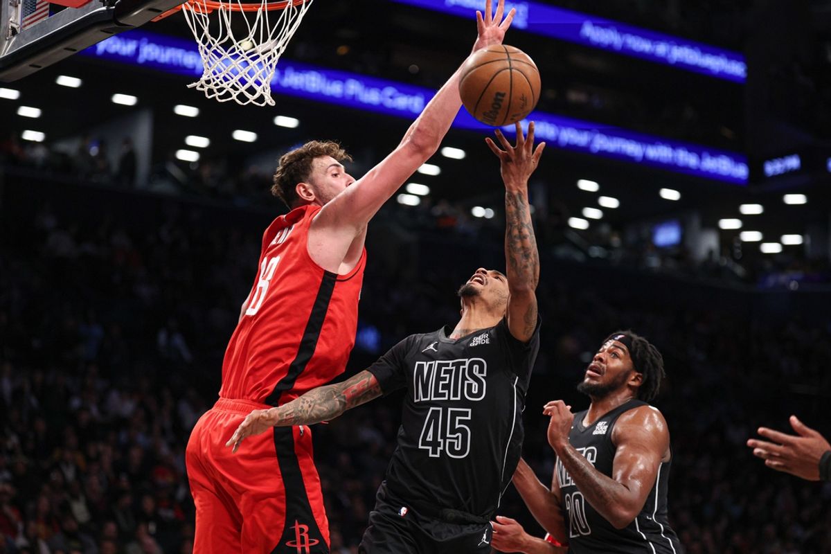 Feb 4, 2025; Brooklyn, New York, USA; Brooklyn Nets guard Keon Johnson (45) goes to the basket asHouston Rockets center Alperen Sengun (28) defends during the second half at Barclays Center. Mandatory Credit: Vincent Carchietta-Imagn Images