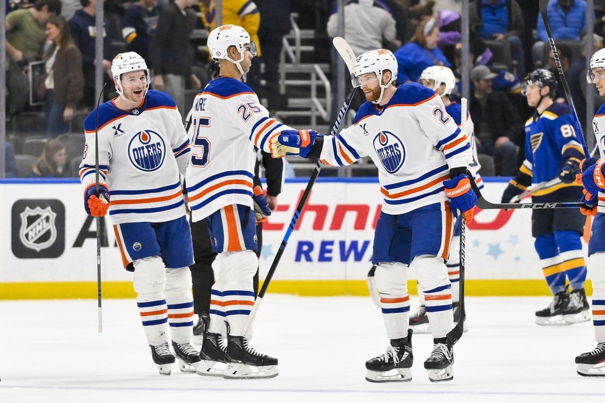 Feb 4, 2025; St. Louis, Missouri, USA;  Edmonton Oilers right wing Connor Brown (28) is congratulated by defenseman Darnell Nurse (25) after scoring the game winning goal against the St. Louis Blues in overtime at Enterprise Center. Mandatory Credit: Jeff Curry-Imagn Images