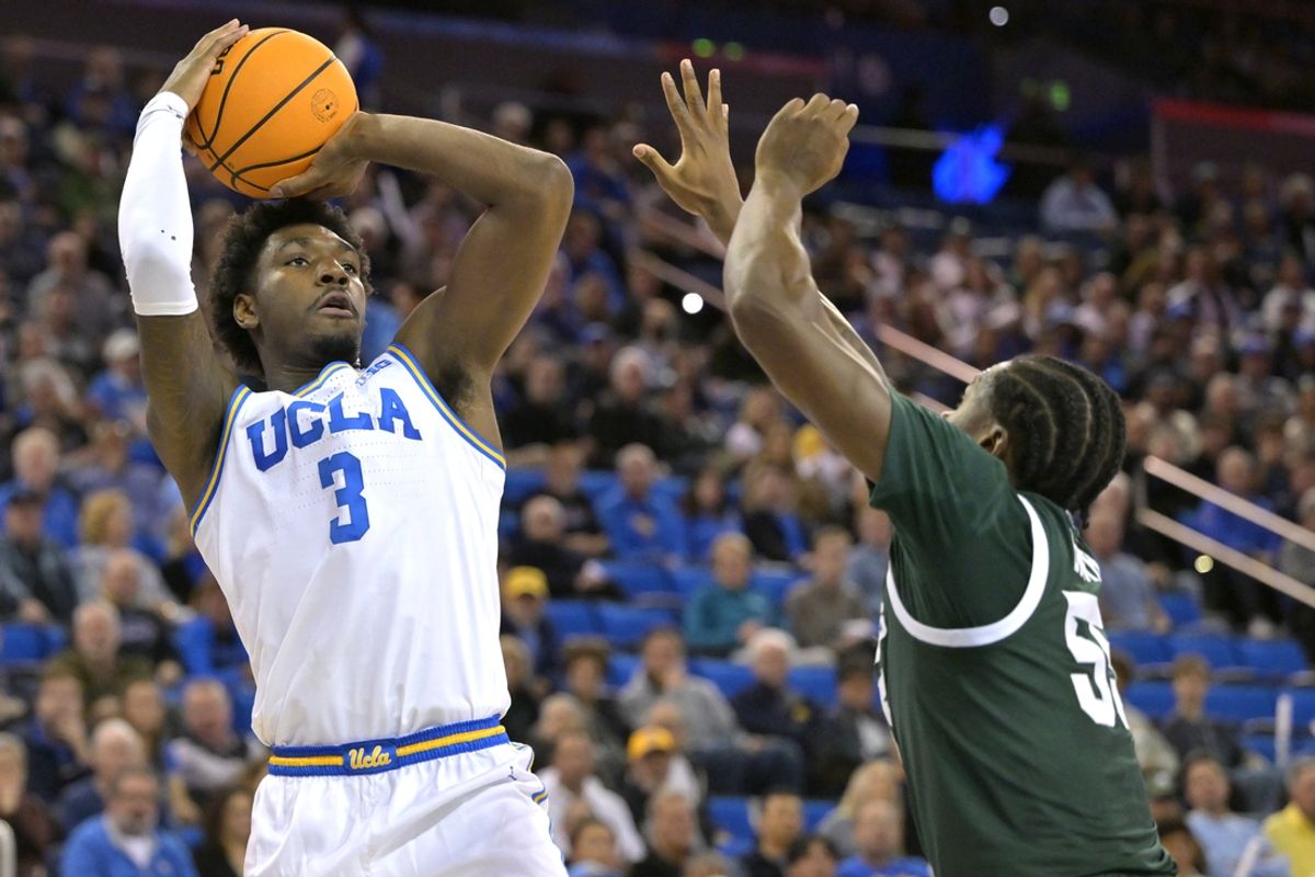 Feb 4, 2025; Los Angeles, California, USA; UCLA Bruins guard Eric Dailey Jr. (3) shoots over Michigan State Spartans forward Coen Carr (55) in the first half at Pauley Pavilion presented by Wescom. Mandatory Credit: Jayne Kamin-Oncea-Imagn Images