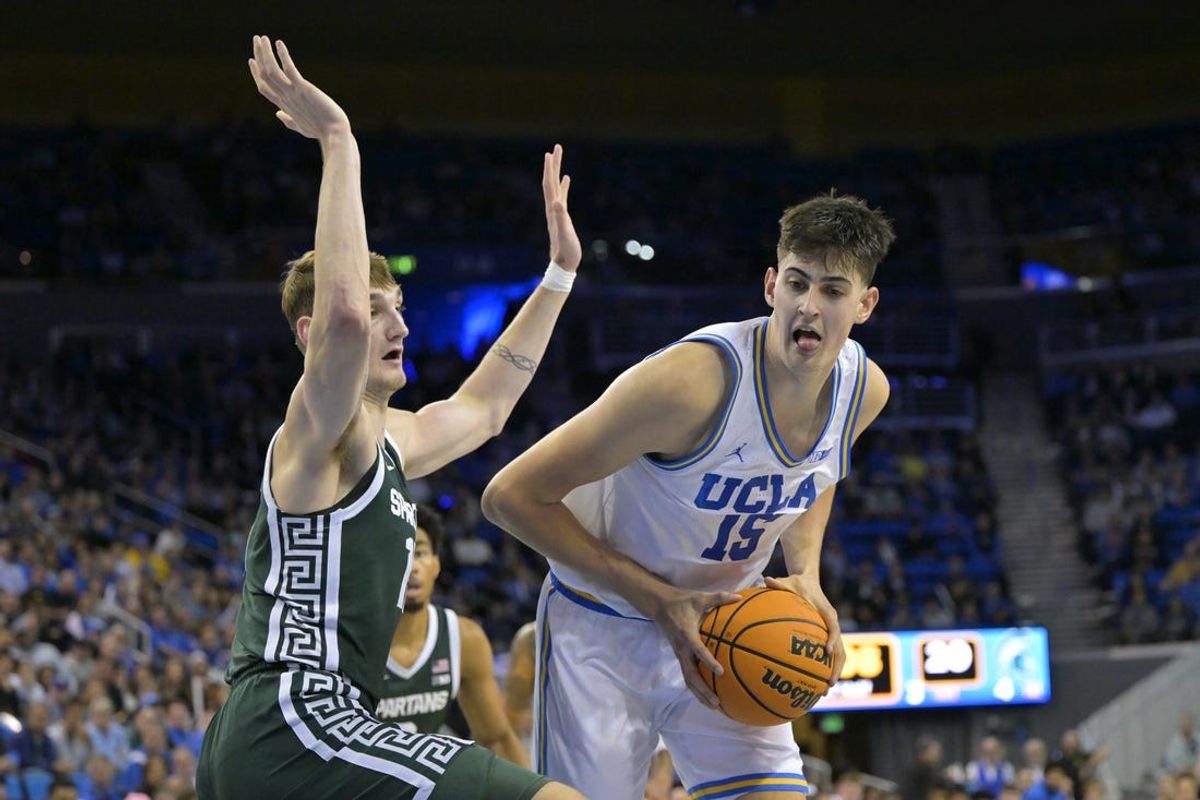 Feb 4, 2025; Los Angeles, California, USA; Michigan State Spartans center Carson Cooper (15) defends a shot by UCLA Bruins center Aday Mara (15) in the first half at Pauley Pavilion presented by Wescom. Mandatory Credit: Jayne Kamin-Oncea-Imagn Images