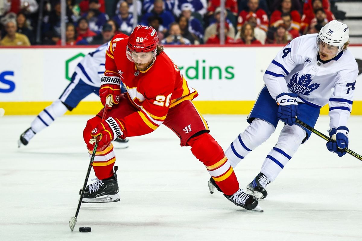 Feb 4, 2025; Calgary, Alberta, CAN; Calgary Flames left wing Blake Coleman (20) controls the puck against the Toronto Maple Leafs during the third period at Scotiabank Saddledome. Mandatory Credit: Sergei Belski-Imagn Images