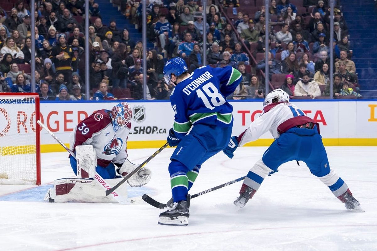 Feb 4, 2025; Vancouver, British Columbia, CAN; Colorado Avalanche defenseman Samuel Girard (49) watches as goalie Mackenzie Blackwood (39) makes a save on Vancouver Canucks forward Drew O'Connor (18) in the second period at Rogers Arena. Mandatory Credit: Bob Frid-Imagn Images