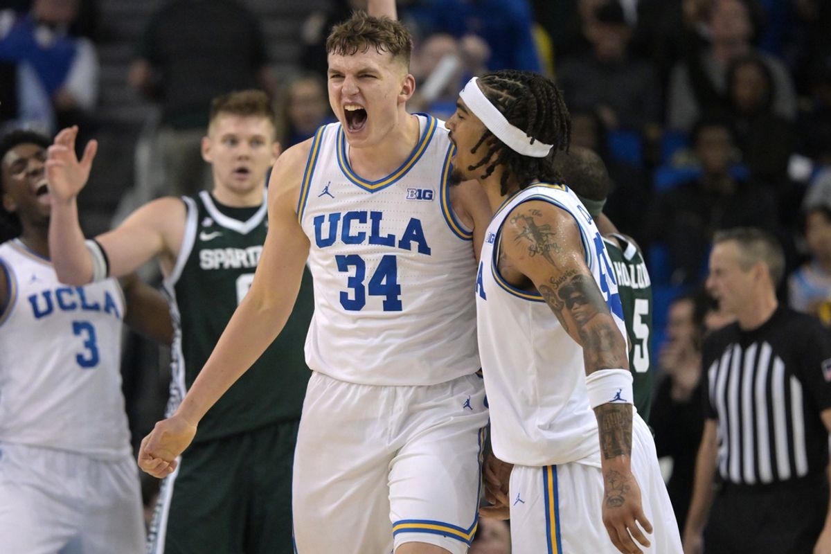 Feb 4, 2025; Los Angeles, California, USA; UCLA Bruins guard Skyy Clark (55) and forward Tyler Bilodeau (34) celebrate after a basket during the second half against the Michigan State Spartans at Pauley Pavilion presented by Wescom. Mandatory Credit: Jayne Kamin-Oncea-Imagn Images