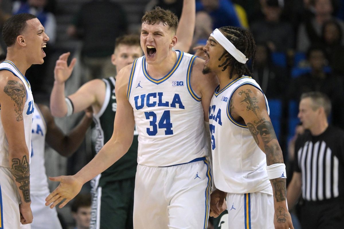 Feb 4, 2025; Los Angeles, California, USA; UCLA Bruins guard Kobe Johnson (0) and guard Skyy Clark (55) celebrate with forward Tyler Bilodeau (34) after a basket during the second half against the Michigan State Spartans at Pauley Pavilion presented by Wescom. Mandatory Credit: Jayne Kamin-Oncea-Imagn Images